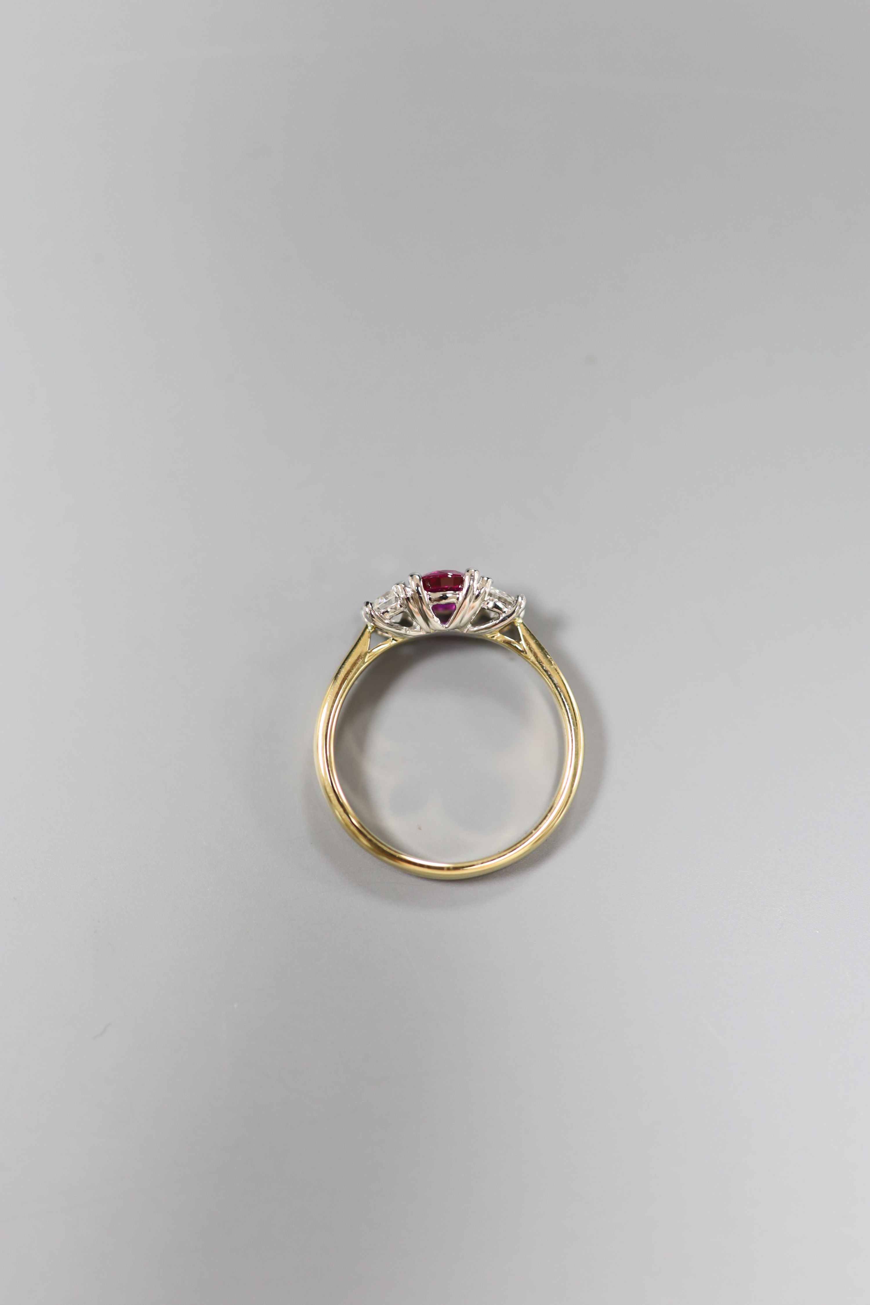 A modern 18ct gold and platinum, ruby and diamond set three stone ring, size M, gross 3.3 grams.